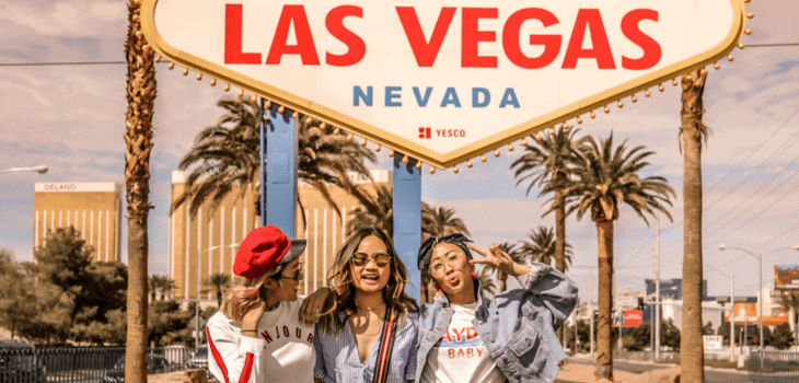 Influencers posing in front of the Las Vegas sign