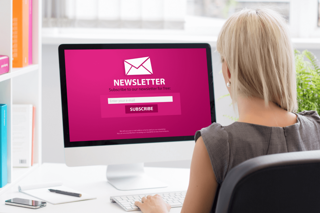 A person subscribing to a marketing newsletter on their computer