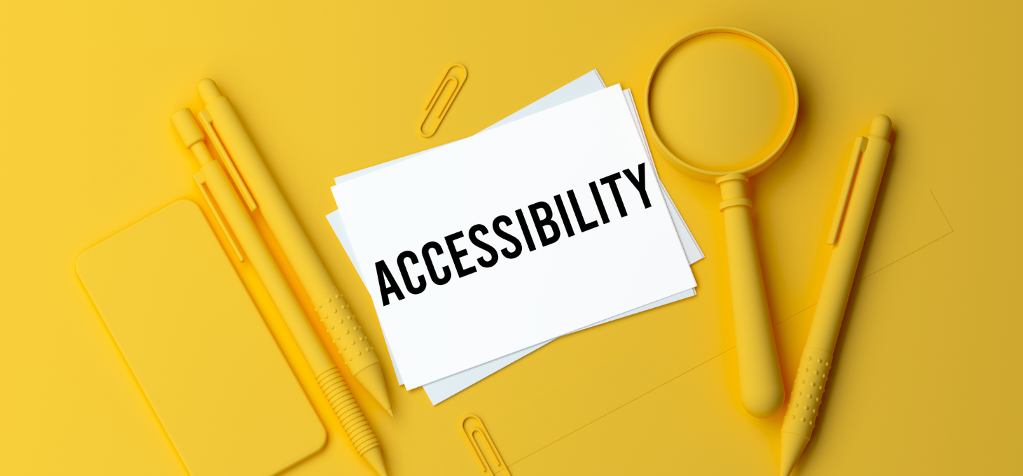 The word “accessibility” written on a paper surrounded by yellow objects