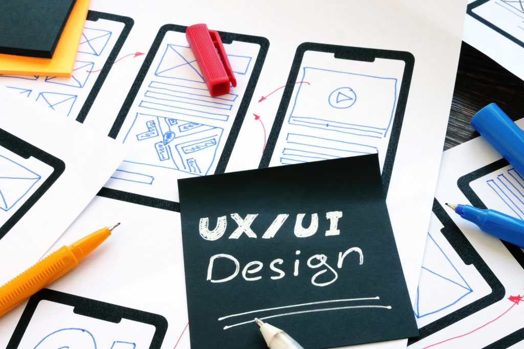 The words “UX/UI Design” written on a black paper