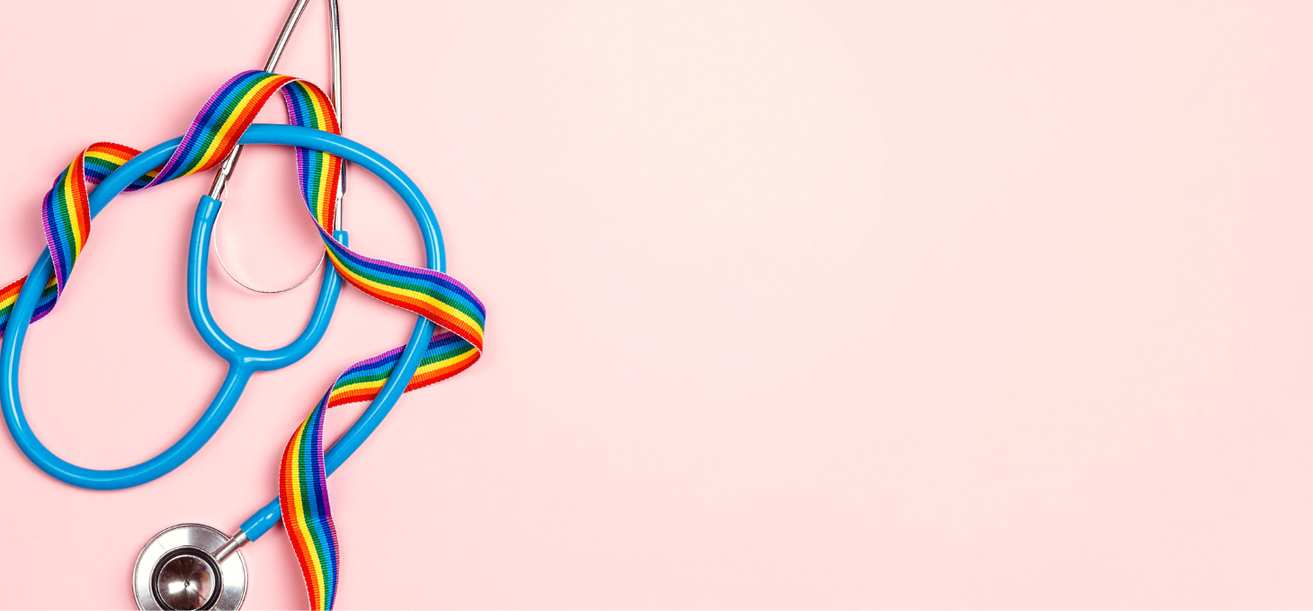 A rainbow ribbon intertwined with a stethoscope against a pink backdrop