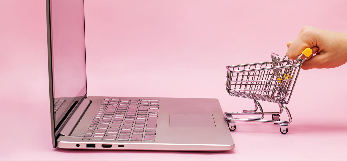 A laptop and a mini shopping cart