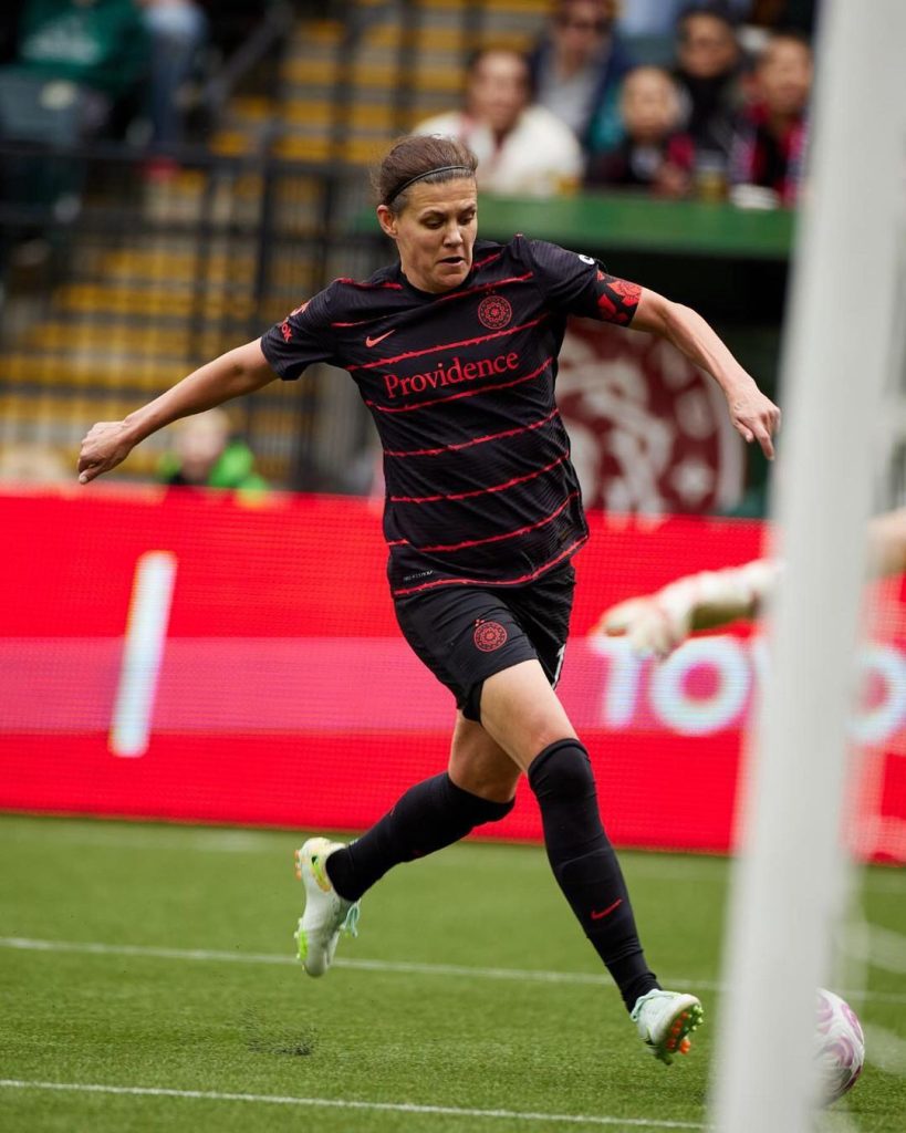 Canadian soccer player, Christine Sinclair, dribbling a soccer ball