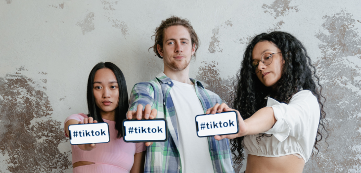 Three influencers holding up their phones with #TikTok on the screens