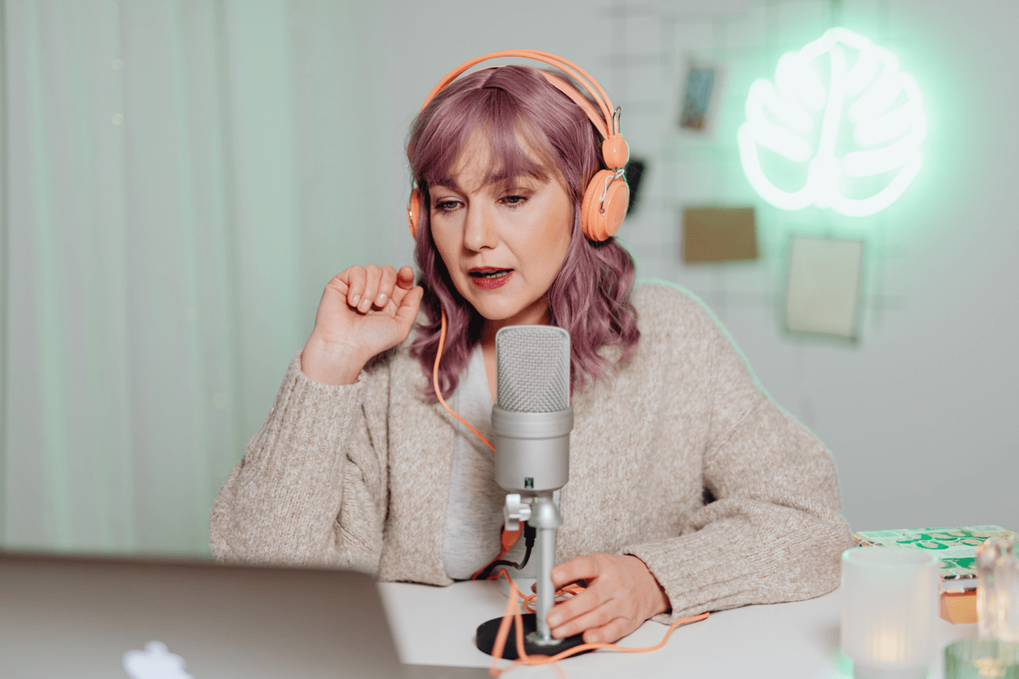 an influencer wearing headphones speaking into a microphone