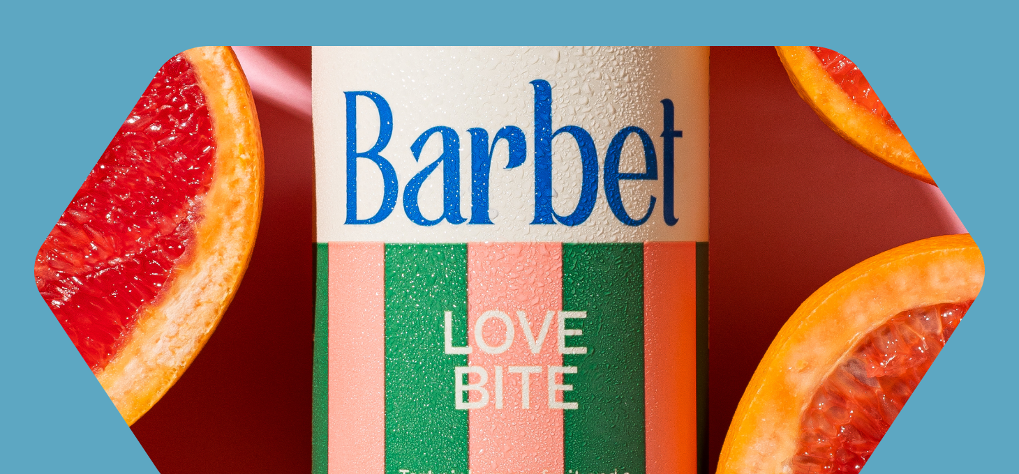 Close up of a can of Barbet sparkling water next to grapefruit slices